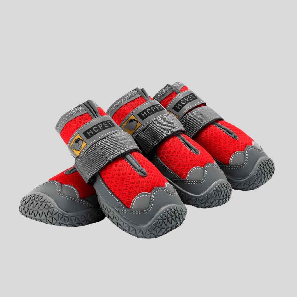 Four durable dog boots stacked, showcasing the rugged sole for outdoor dog gear.