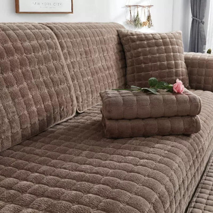 Close-up of quilted flannel sofa cover texture, anti-slip backing, durable home decor.