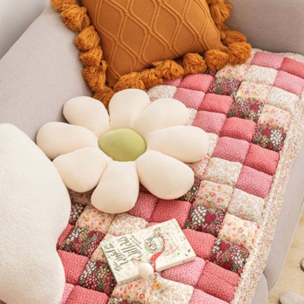 Machine washable non-slip quilted floral couch cover draped over a sofa, enhancing home decor.