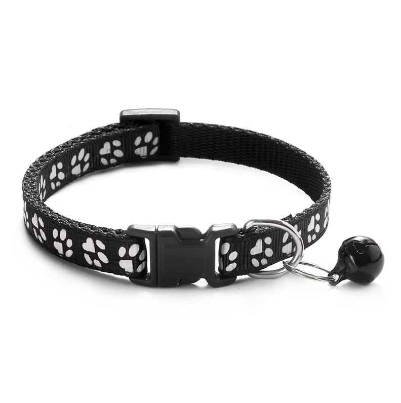 Close-up of the quick release buckle on a green adjustable cat collar with bell