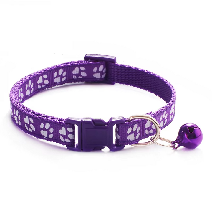 Yellow cat safety collar with bell and paw print design, adjustable strap