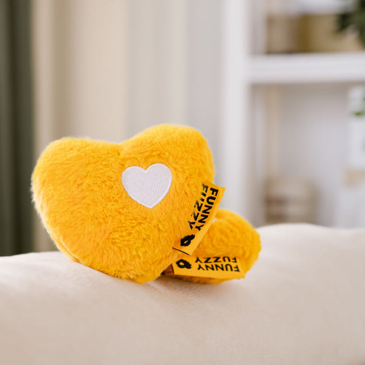Heart-shaped dog toy made of soft plush material, designed with an internal squeaker for pet entertainment.