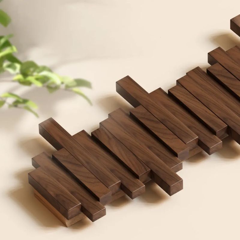Natural wood folding wall hanger, perfect for entryways. Space-saving coat rack with modern aesthetic.