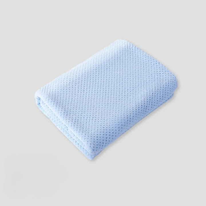 Soft coral fleece pet blanket in a cozy blue, perfect for dog and cat comfort.