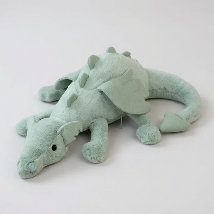 Soft green plush dragon toy with long tail, perfect cuddly adventure friend for children & nursery decor.