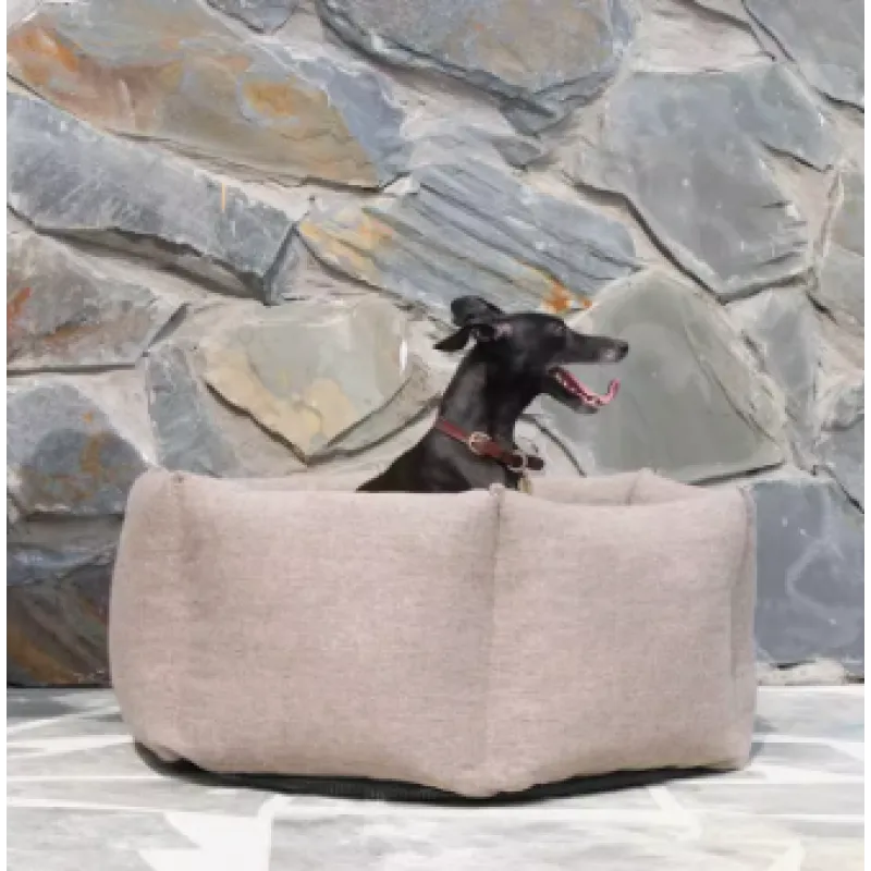 Beige high-sided dog bed, offering warmth and support for a restful sleep, a pet essential.