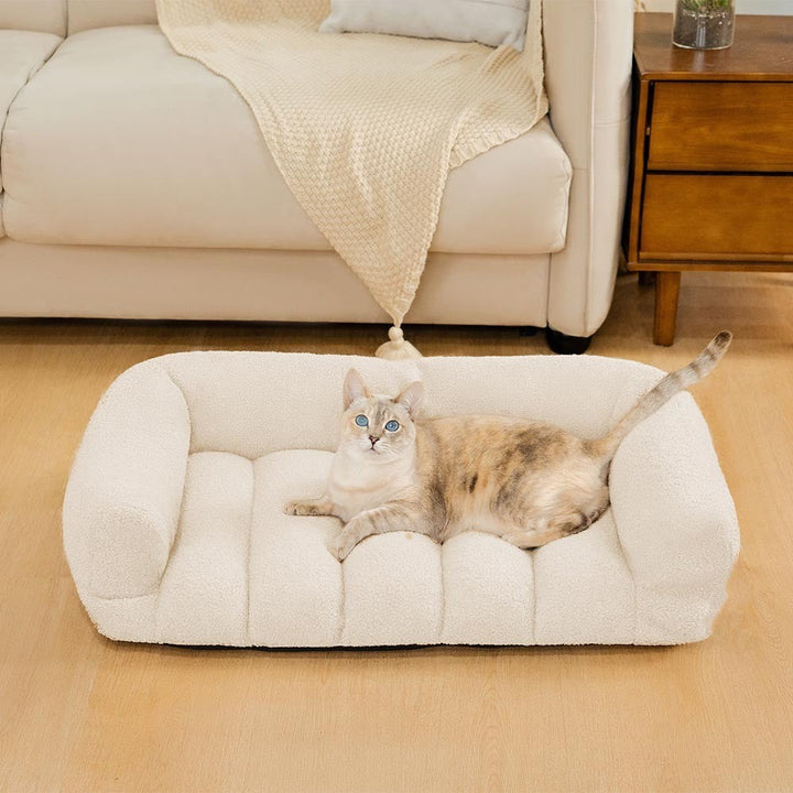 Soft plush orthopedic cat bolster bed with supportive headrest, ideal for cozy relaxation