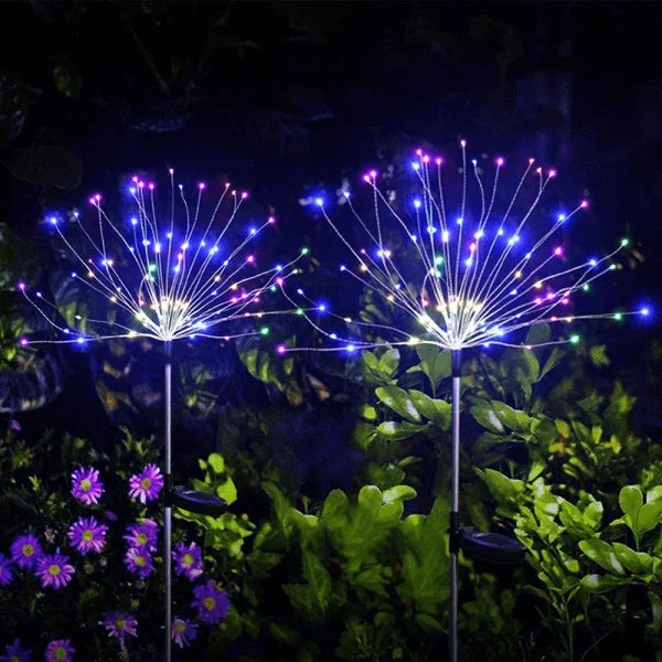 Garden path adorned with solar powered firework lights, creating a magical night-time scene.