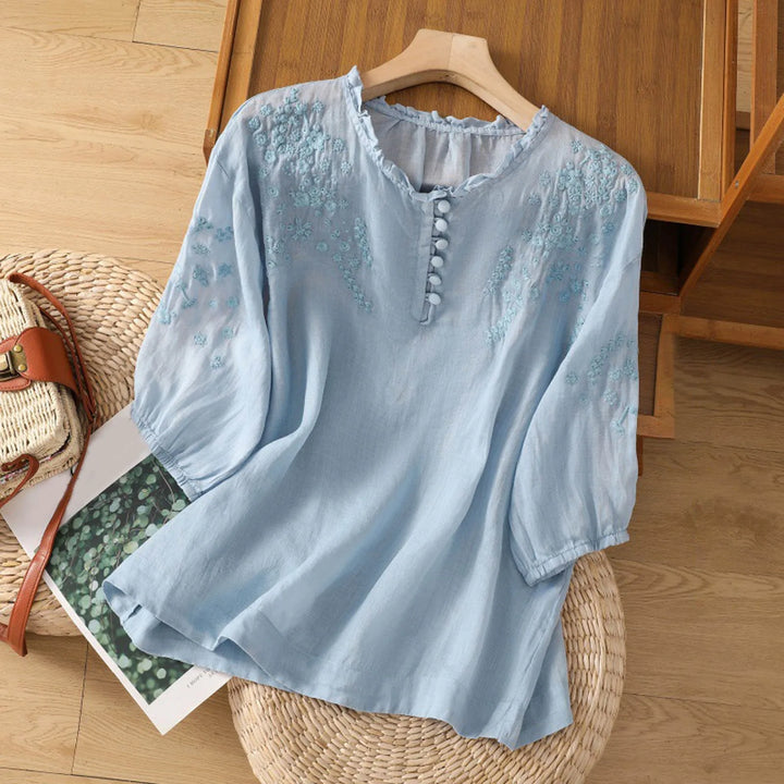 Sophisticated women's embroidered blouse with vintage touch. Elegant long-sleeve top for casual or work wear.
