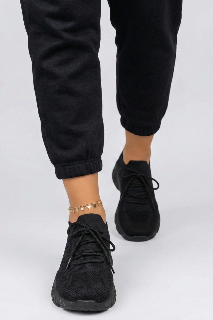 Close-up of women's lace-up sneakers showcasing textured grip sole for stable footing in athletic & casual settings.