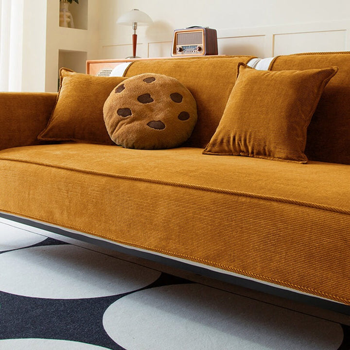 Close-up of the soft corduroy fabric of an anti-slip sofa cover, perfect for homes with pets.