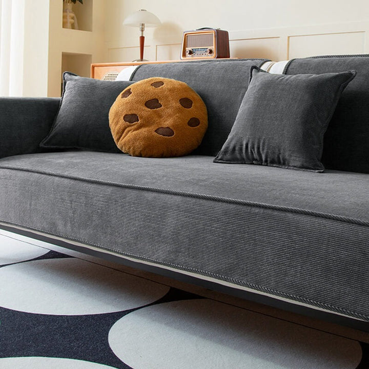 Easy-clean corduroy sofa cover with anti-slip backing, a practical solution for pet-friendly living rooms.