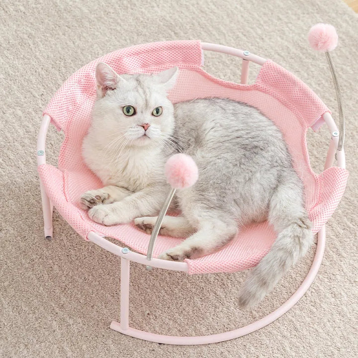 Comfortable blue cat bed, round hammock with dangling toys on a sturdy metal frame