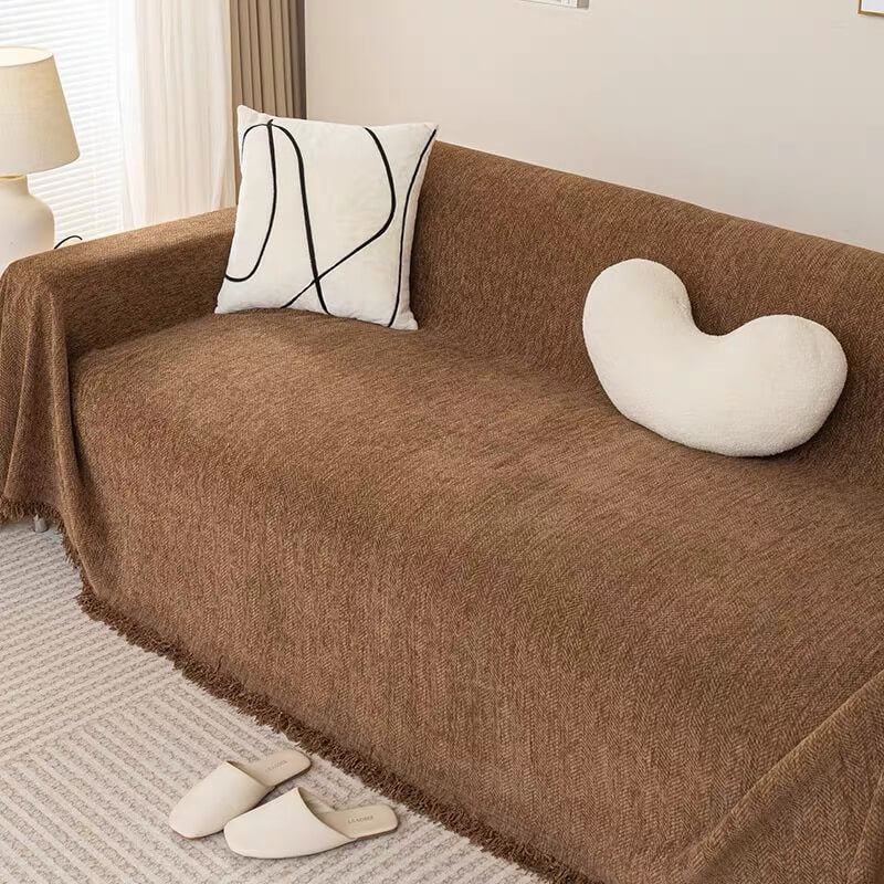 Corner detail of elasticized chenille herringbone sofa cover, snug fit on couch