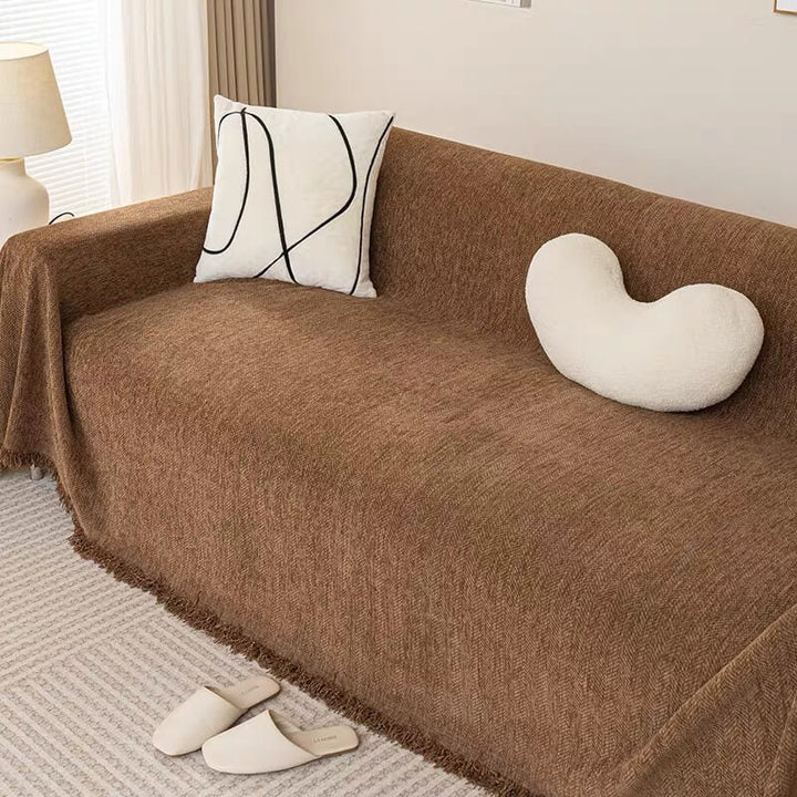 Corner detail of elasticized chenille herringbone sofa cover, snug fit on couch