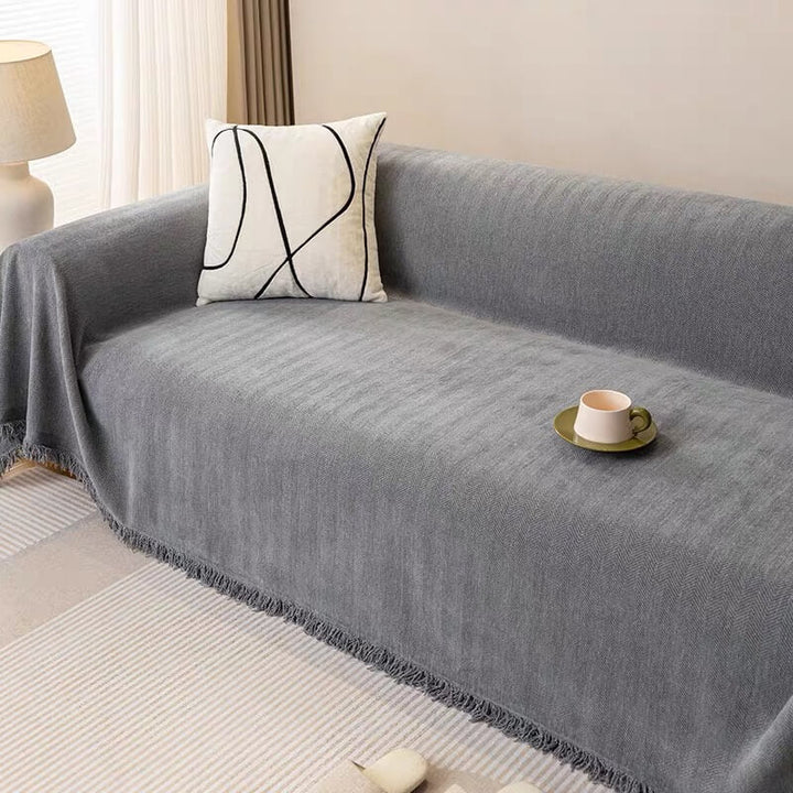 Unisex herringbone sofa cover protecting couch from pets, durable and easy to clean