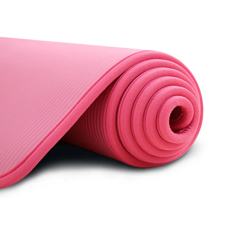 Black extra thick yoga mat with non-slip surface, providing comfort & joint protection for pilates and fitness.