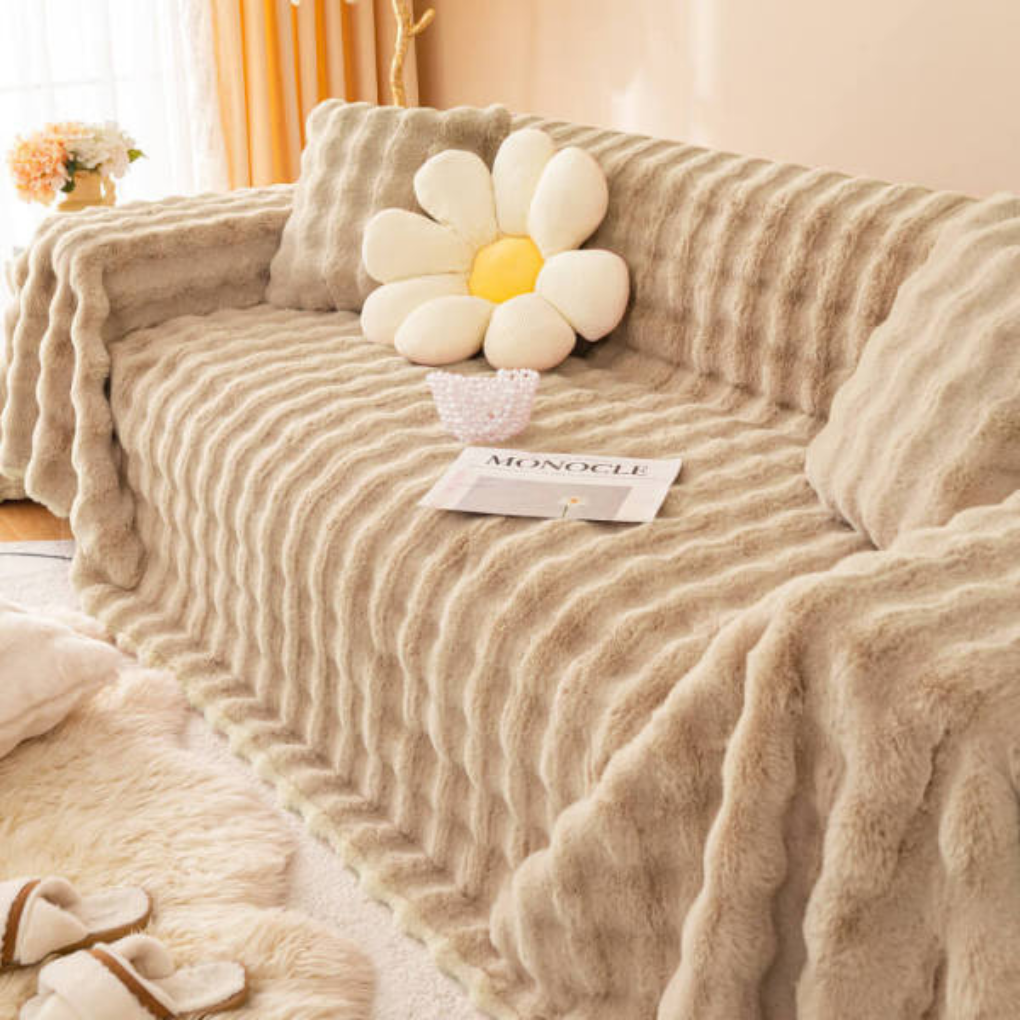 Pets sitting on a comfortable faux rabbit fur sofa cover, highlighting its pet-friendly design