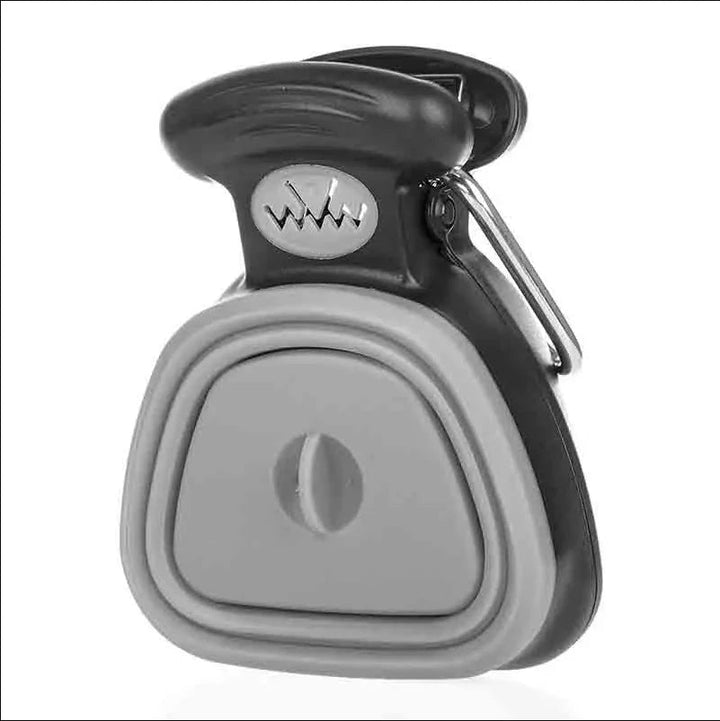 Foldable dog poop scooper in use, demonstrating one-handed pet waste collection with eco-bags