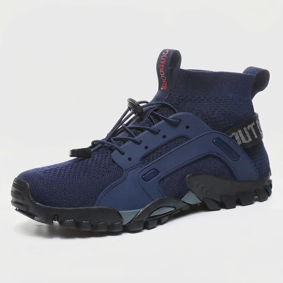 Unisex high-top trail shoes in action on a rocky path, showcasing all-terrain grip & comfortable ankle support for hiking.