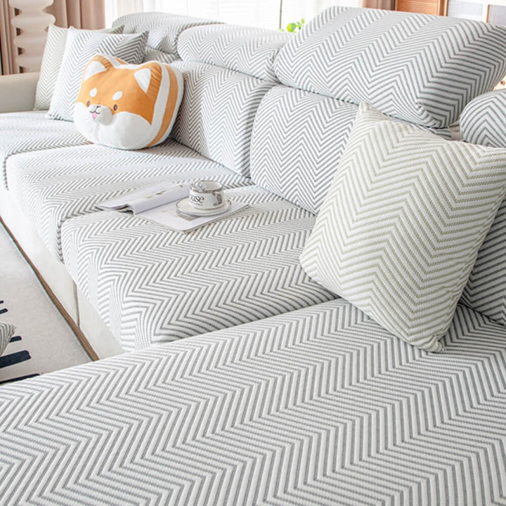Detailed shot of the elastic band and anti-slip features of the ice silk stretch sofa cover.