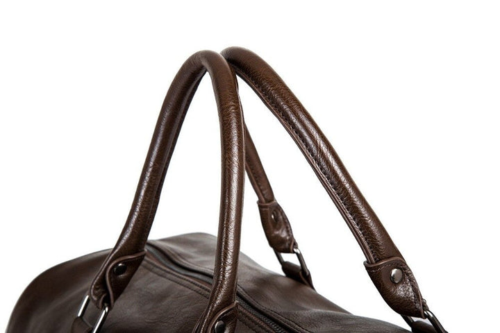 Spacious brown faux leather unisex travel duffel, perfect as a carry-on or weekend bag.