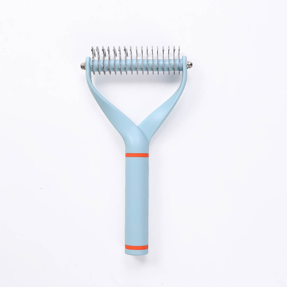 A cat being groomed gently with the double-sided Pet Dematting Comb, showing effective pet care.