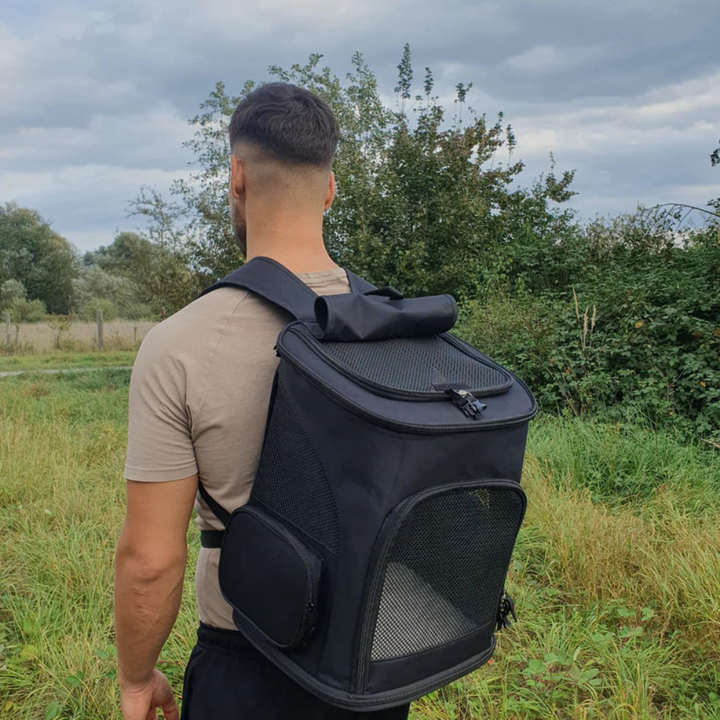 Ventilated pet travel carrier backpack in grey, suitable for cats and small animals, side view
