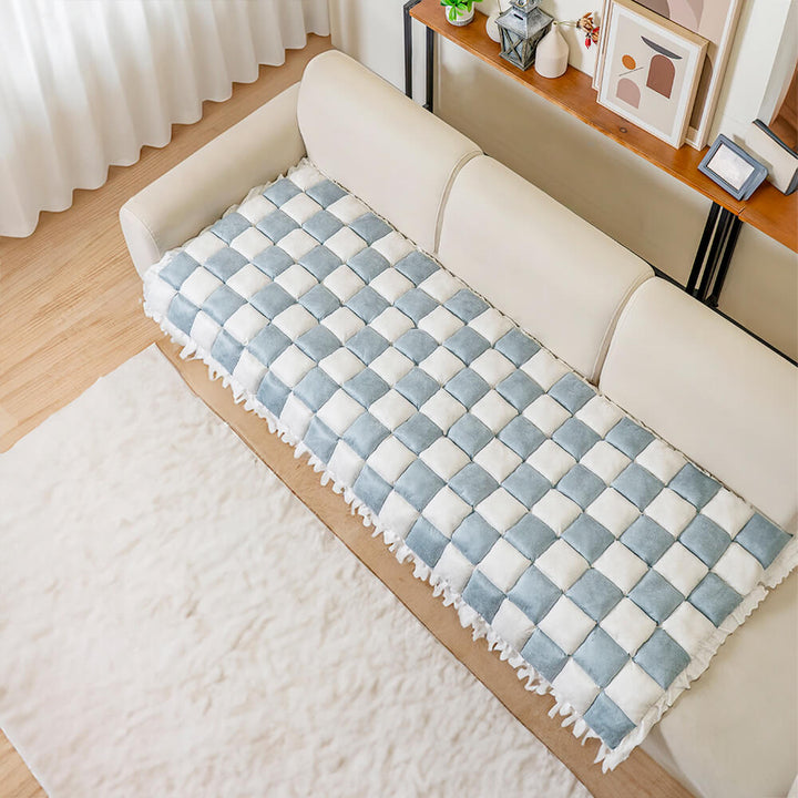 Folded plaid couch cover, emphasizing portability and easy storage, pet supplies