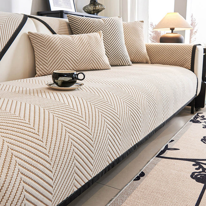Unisex two-tone herringbone couch cover protecting a sofa from spills and wear