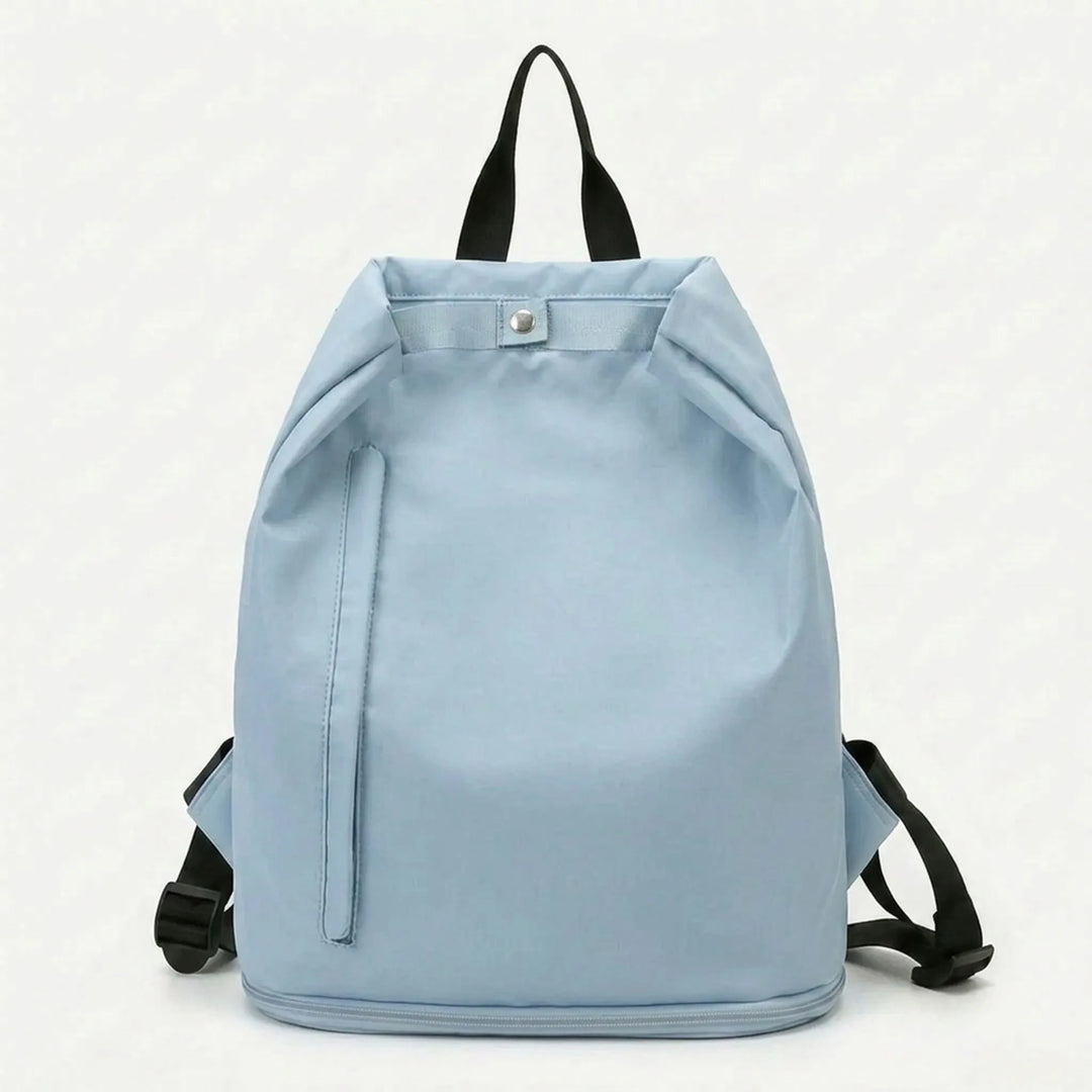 Close-up of the ventilated shoe compartment on a sleek black unisex travel sports backpack, showing its depth.
