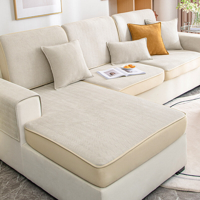 Pet-friendly universal stretch sofa slipcover, herringbone chenille, covering a brown leather couch