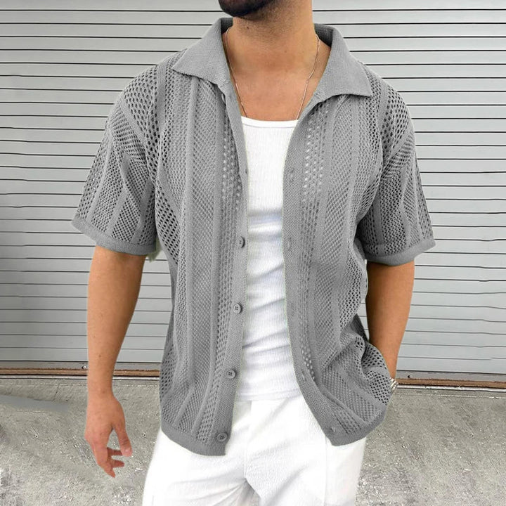 Comfortable men's casual top with a hollow knit, short sleeves, and relaxed fit, great for warm weather.