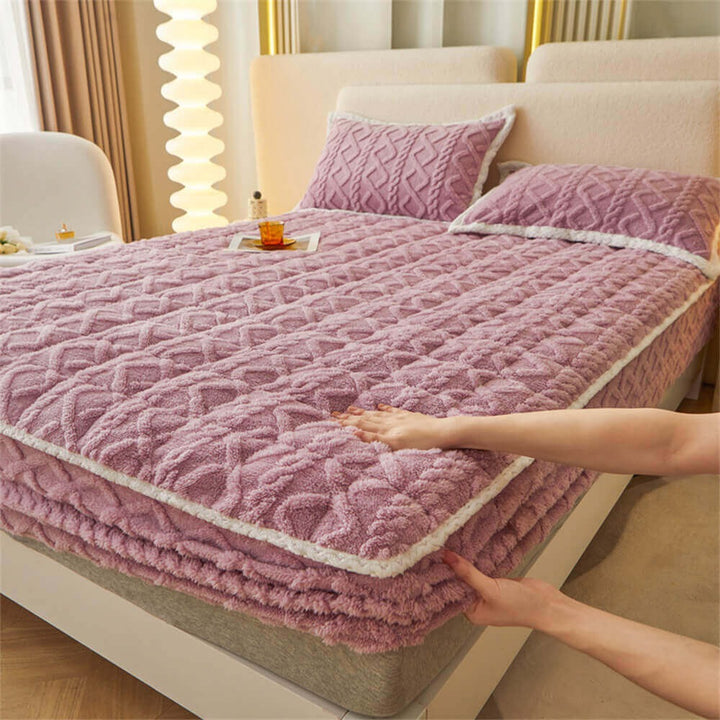 Fitted sheet mattress cover on a bed, highlighting its snug fit and plush, fluffy surface.