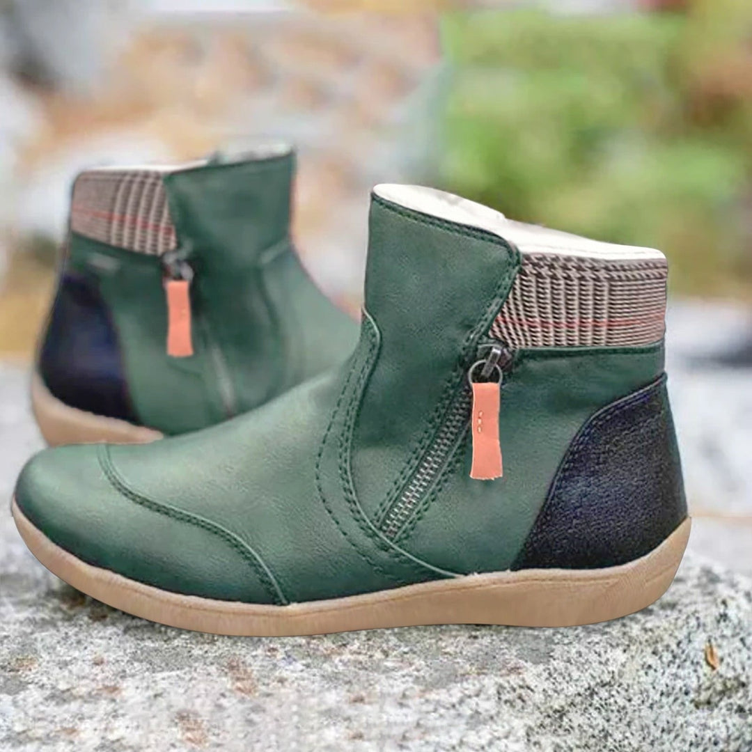 Women's black waterproof ankle boots with side zipper, perfect for all-weather comfort & traction.