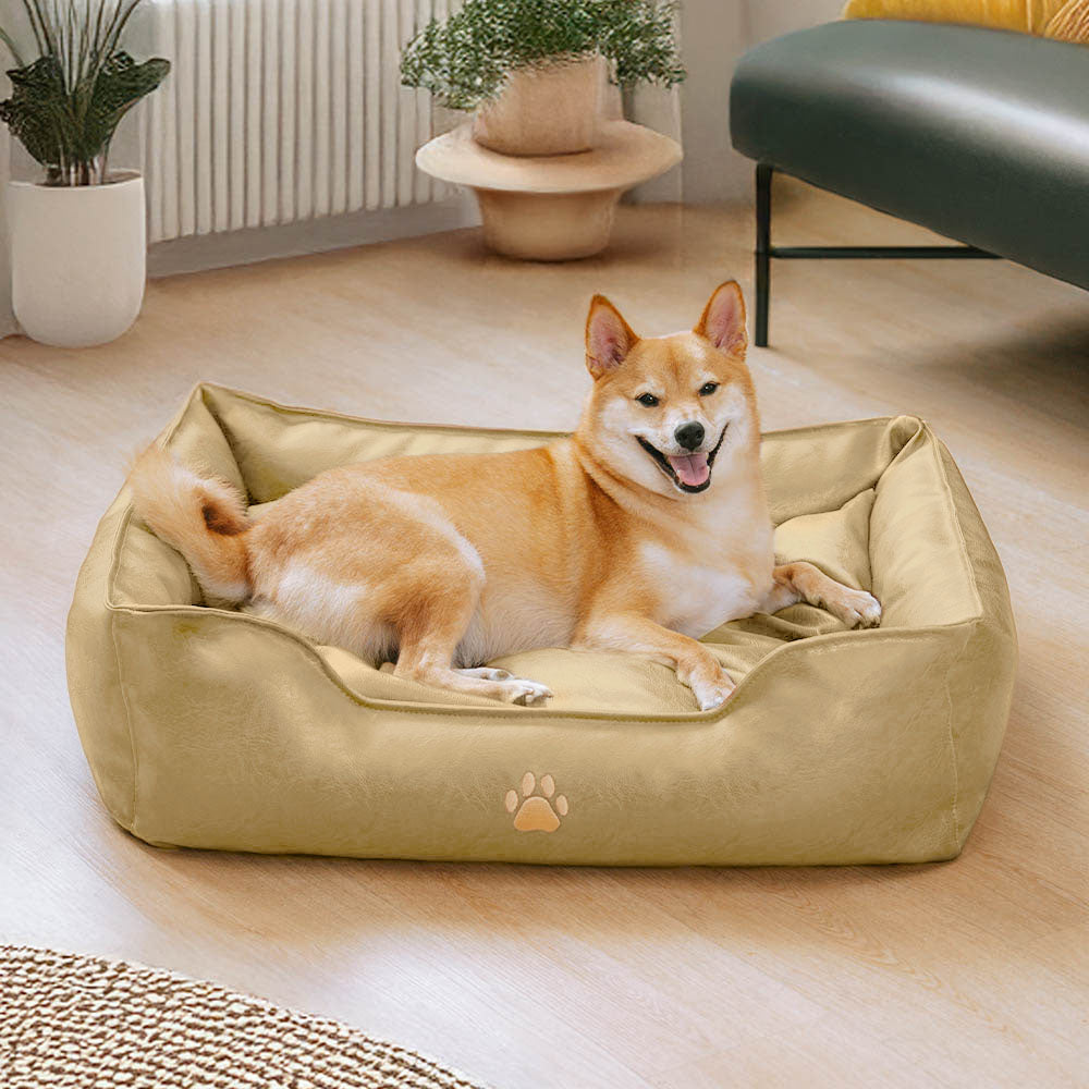 Indoor photo of a waterproof faux leather pet sofa bed, a comfortable and robust dog accessory