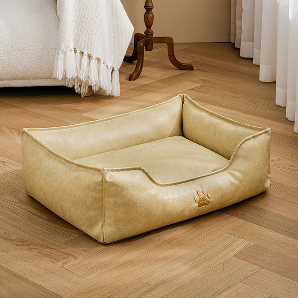 Waterproof faux leather dog bed with an integrated pillow design, ultimate comfort for pets