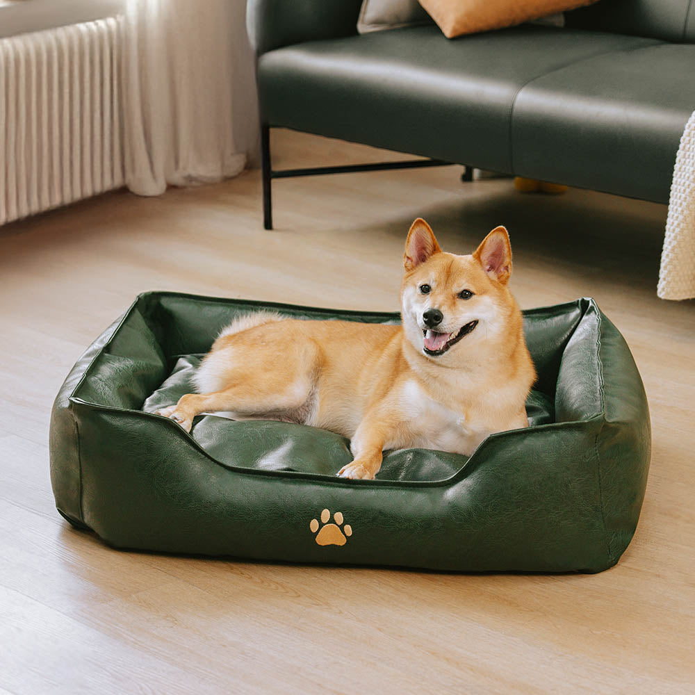 Happy dog playing on a waterproof faux leather pet bed, a durable and comfortable dog sofa