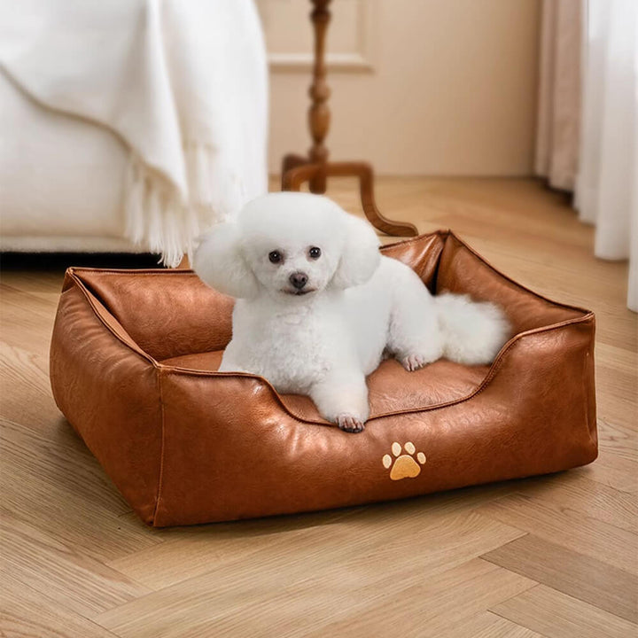 Detail of the supportive bolster on a waterproof faux leather dog bed, comfortable pet furniture for aging dogs