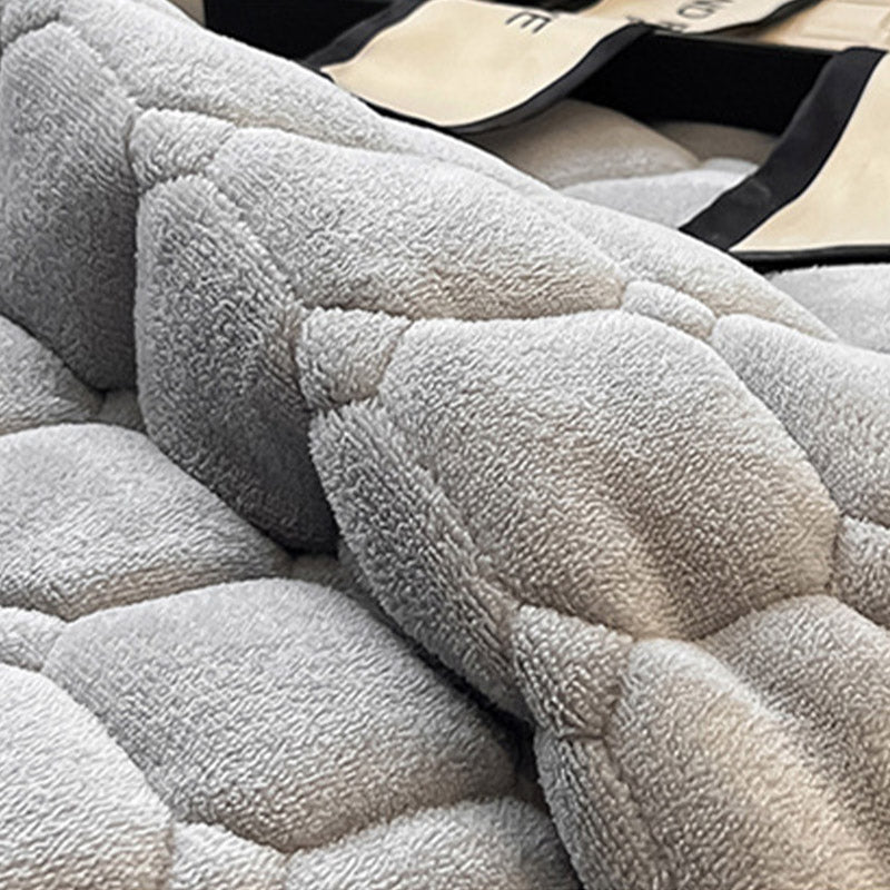 "Weiche Tagesdecke mit quadratischer Textur, flauschig und modern auf Sofa drapiert, verleiht stilvolle Gemütlichkeit."