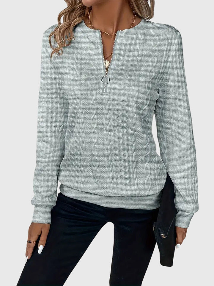 Pink women's cable knit quarter-zip sweater detail. Soft Harlow pullover, cozy winter fashion.