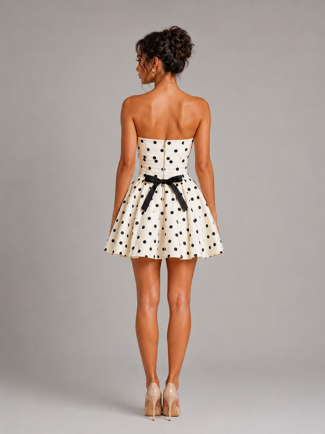 Chic women's strapless polka dot mini homecoming dress with a structured corset bodice, ideal for special occasions.