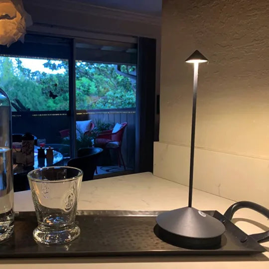Compact dimmable LED table lamp, wireless. Rechargeable portable light for indoor/outdoor home decor.