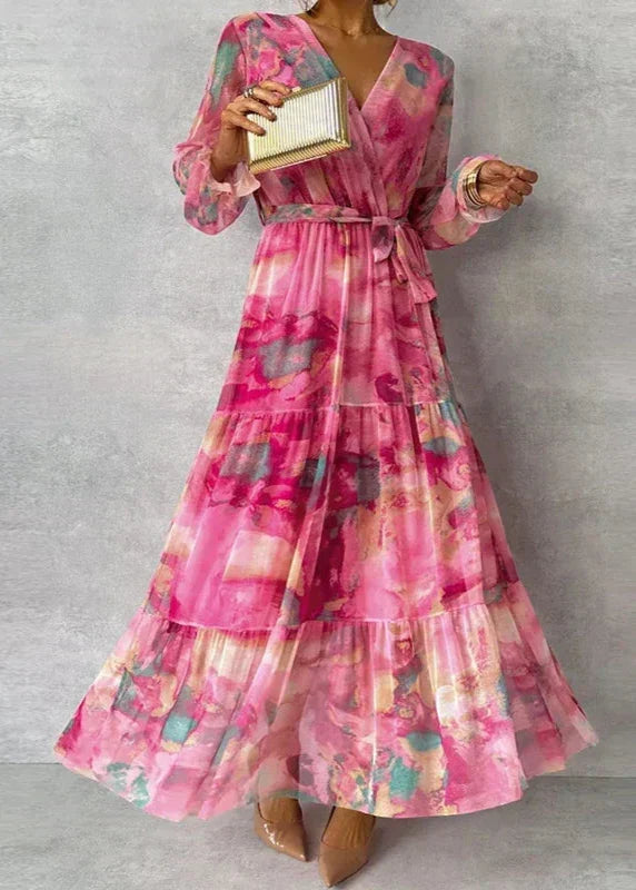 Women's abstract floral wrap maxi dress with V-neck, tie waist, and tiered skirt. Elegant occasion wear.