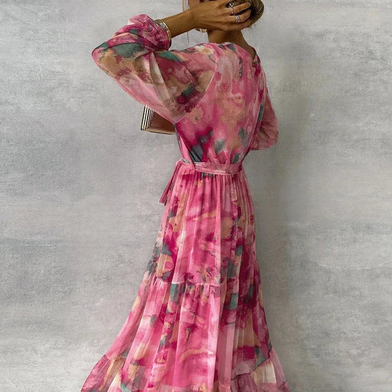 Elegant women's wrap maxi dress with abstract floral print. V-neck, adjustable tie waist, and beautiful tiered skirt.