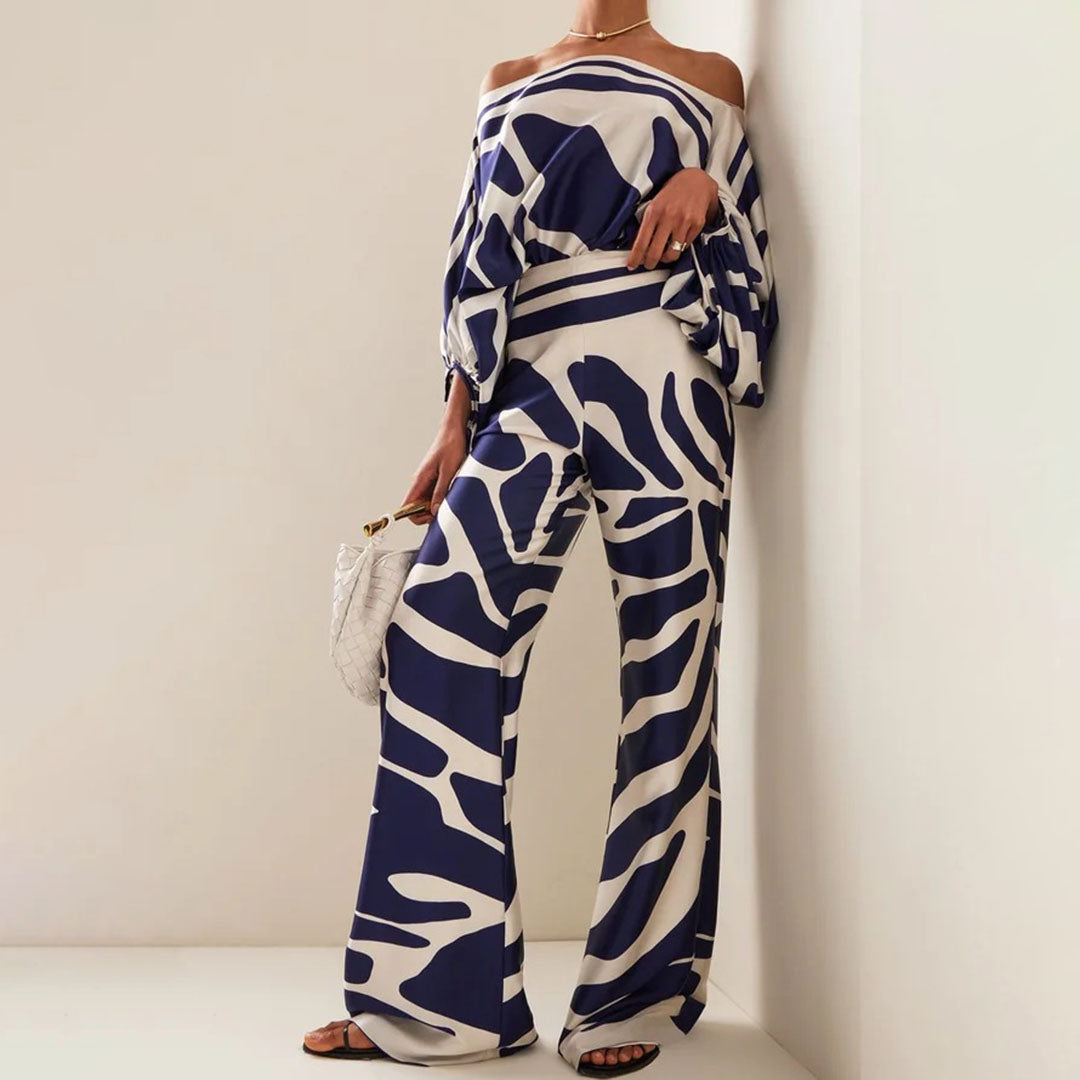 Flowy two-piece women's set featuring a comfortable one-shoulder top and wide-leg artistic print pants.
