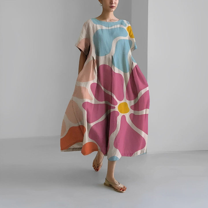 Flowy women's midi dress, relaxed fit, vibrant artistic print. Ideal for comfortable, stylish everyday wear.