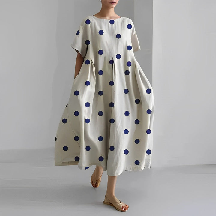 Flowy artistic print midi dress for women. Relaxed, comfortable short-sleeve design, ideal for summer and casual wear.