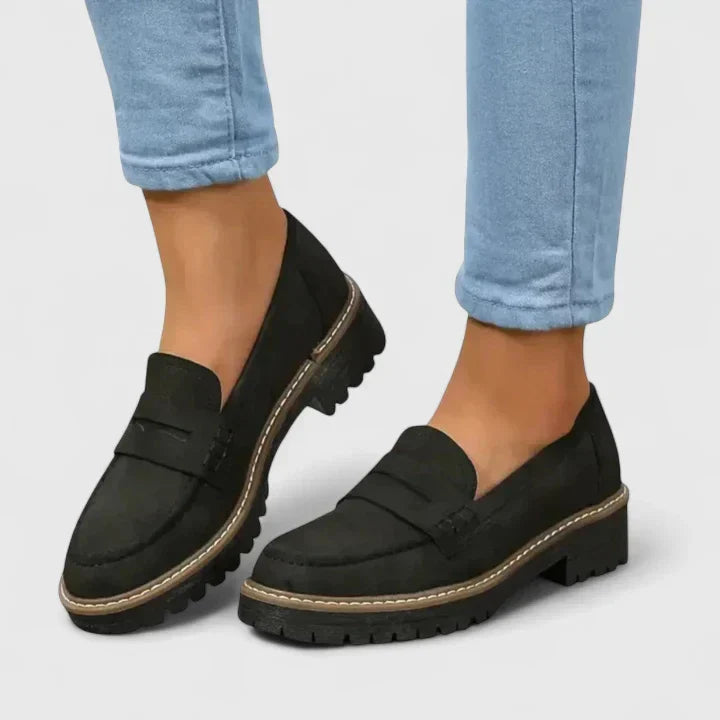 Women's black chunky lug-sole penny loafers, perfect for modern preppy style & versatile casual wear.