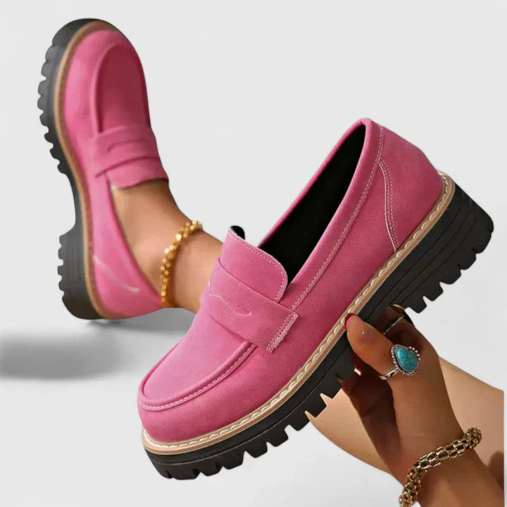 Stylish women's slip-on platform penny loafers with a chunky lug sole, ideal for office or casual chic.